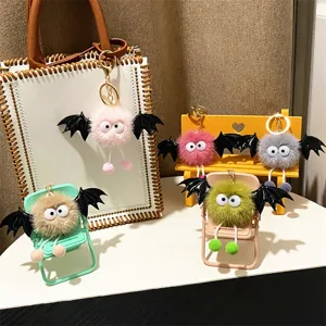 Detailed view of cute colorful bat monster plush keychains on mini chairs