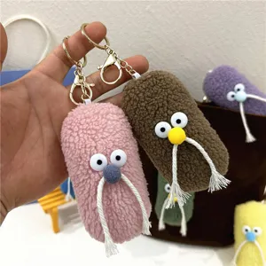 Close-up of quirky plush mustache man keychains in various colors with fuzzy textures.