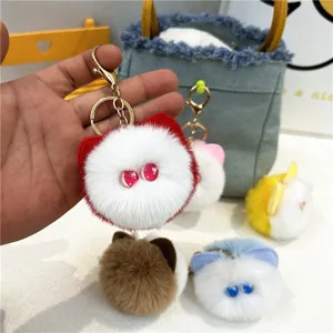 Detailed view of soft plush cat head keychains in various colors for bag charms