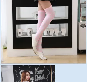 Detail view of pink white striped over-the-knee socks, showing texture and leg pairing effect.