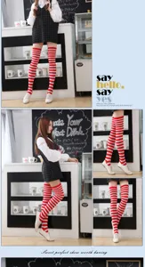 Red and white striped over-the-knee socks close-up view, fashion long hosiery items.