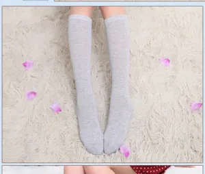 Detail view of soft light grey knee high socks showcasing fine knit texture and comfortable fit.