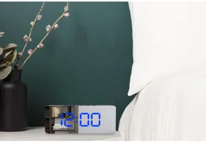 Creative LED mirror digital clock with blue display for modern bedroom and desk decor.