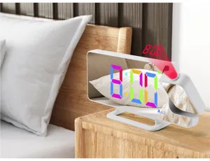 Detail shot of the RGB colorful projection alarm clock with mirror screen on a wooden nightstand.