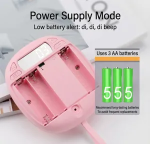 Pink digital alarm clock detail showing the battery compartment and control buttons.