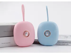 Portable mini hand warmer with cute cartoon design and silicone lanyard, pink and blue.
