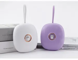 Portable mini digital alarm clock with cute cat button and hanging strap, detail view.