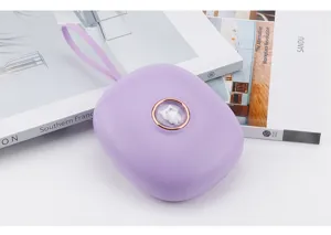 Portable purple vibration alarm clock detail featuring a cute cat button and handy lanyard.