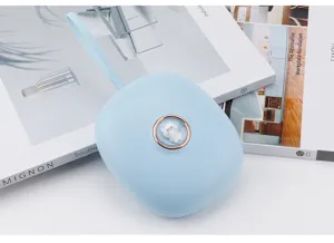 Portable blue mini electronic hand warmer device with wrist strap and cute cat button design.