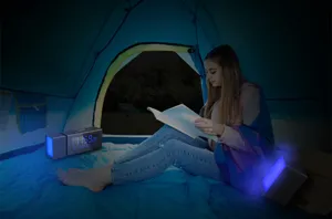 Creative digital alarm clock radio with colorful night light for bedroom and camping use.