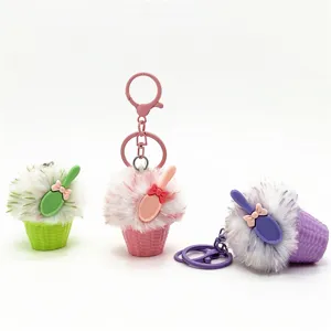 Close-up of three cute plush ice cream dessert keychains in green, pink and purple