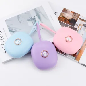 Portable vibrating alarm clock with cute cat button and lanyard in pastel colors.
