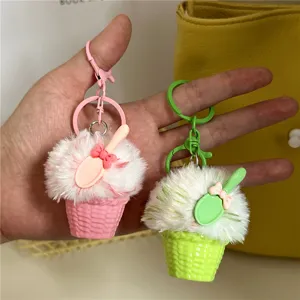 Close-up detail of cute plush ice cream keychain charms in soft pink and green colors
