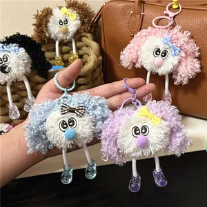 Detailed view of colorful curly plush doll keychains with cute big eyes and bows