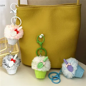 Close-up view of cute colorful ice cream plush keychains hanging on a yellow leather bag.