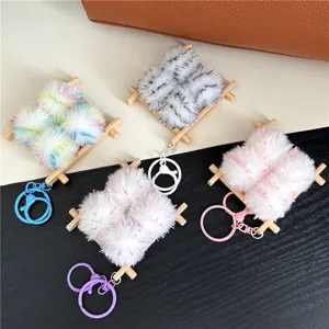 Detailed view of four cute plush tofu-shaped keychains in soft pastel colors for bags