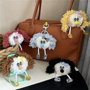 Set of five colorful curly hair plush doll keychains with bows and dangling legs.