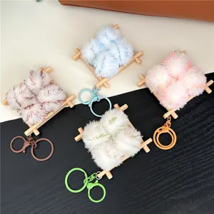 Detail view of four colorful stinky tofu plush keychains on mini wooden pallets