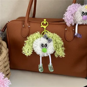 Cute curly hair plush doll keychain accessory hanging on a brown leather handbag