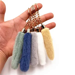 Detailed view of five colorful soft plush keychain charms for cute bag decoration