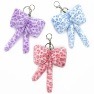 Three colorful leopard print plush bow keychains with metal clasps for bag charms