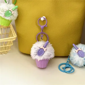 Close-up of cute purple furry ice cream cone keychain charm hanging on a yellow bag