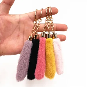 Collection of colorful plush faux fur tail keychains in various vibrant shades.