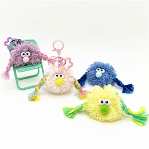 Colorful collection of funny fuzzy monster plush keychains with braided arms and big eyes