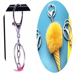 Detail view showing the silver lobster clasp and the yellow plush ice cream cone keychain