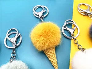 Macro view of plush pom-pom ice cream cone keychains in various vibrant colors.