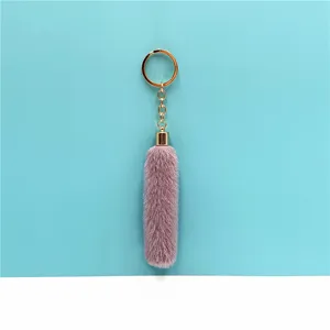 Close-up detail of soft lavender plush tassel keychain with a gold-tone metal ring