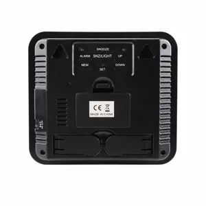Digital alarm clock back view with battery compartment, wall mount and function buttons.