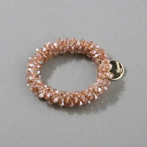 Detailed view of handmade beaded hair scrunchie with faceted champagne crystal beads
