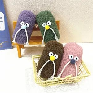 Detailed view of colorful fuzzy plush mustache charms displayed in a basket and on a bench