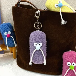 Detailed view of colorful plush mustache keychains used as cute cartoon bag accessories