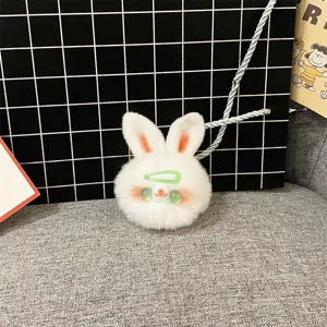 Detailed close-up of a cute white plush bunny keychain with a green hair clip.