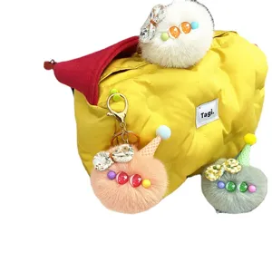 Set of cute plush ice cream doll keychains in vibrant colors hanging on a yellow bag