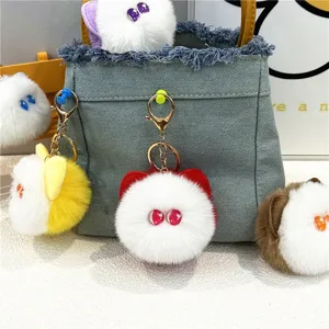 Multiple colors of cute plush cat head keychains used as decorative bag charms