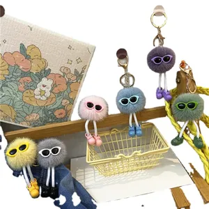 Adorable plush soot sprite keychain featuring sunglasses and long legs for bag charm