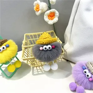 Group of colorful fuzzy soot sprite plush bag charms featuring knitted hats and big eyes