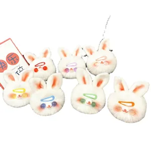 Set of seven cute white plush rabbit keychains with colorful hair clip accessories.