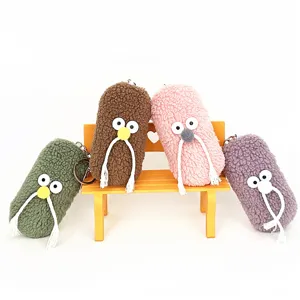 Four cute and funny plush bearded mister keychains in different colors on a yellow bench