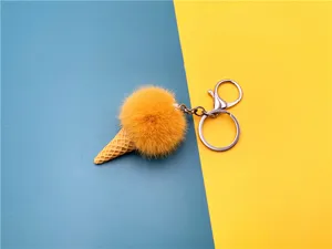 Detail of cute plush ice cream cone keychain on a vibrant blue and yellow background