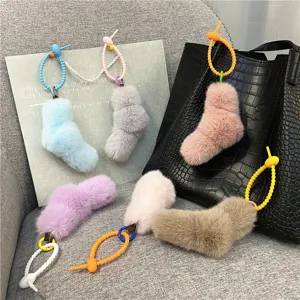 Colorful plush sock charms with decorative twisted knot straps for bags and keychains