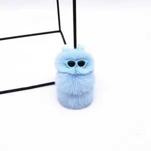 Detail shot of a cute light blue plush caterpillar keychain with sunglasses accessory.