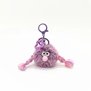 Detail of purple fluffy monster keychain with cute pigtails and star charm for bags