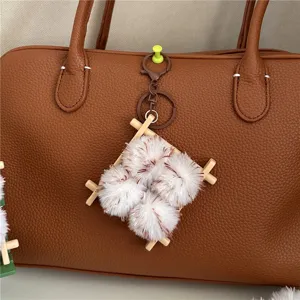 Close-up of a cute plush food-shaped charm on a brown leather bag, ideal bag accessory.