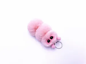Detailed macro view of a cute pink fluffy caterpillar plush keychain and bag charm accessory