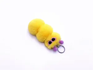 Detailed view of cute yellow caterpillar plush keychain with soft fluffy fur texture