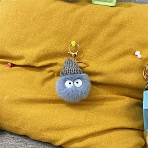 Cute blue plush coal ball keychain charm with grey knit hat and big cartoon eyes